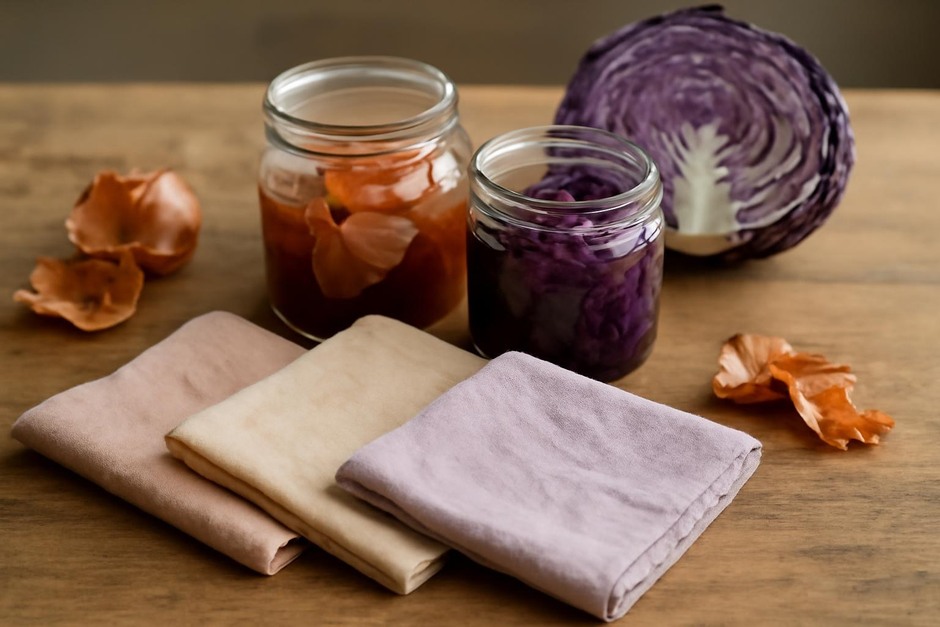 Cotton cloths dyed in soft hues with jars of onion skins and red cabbage